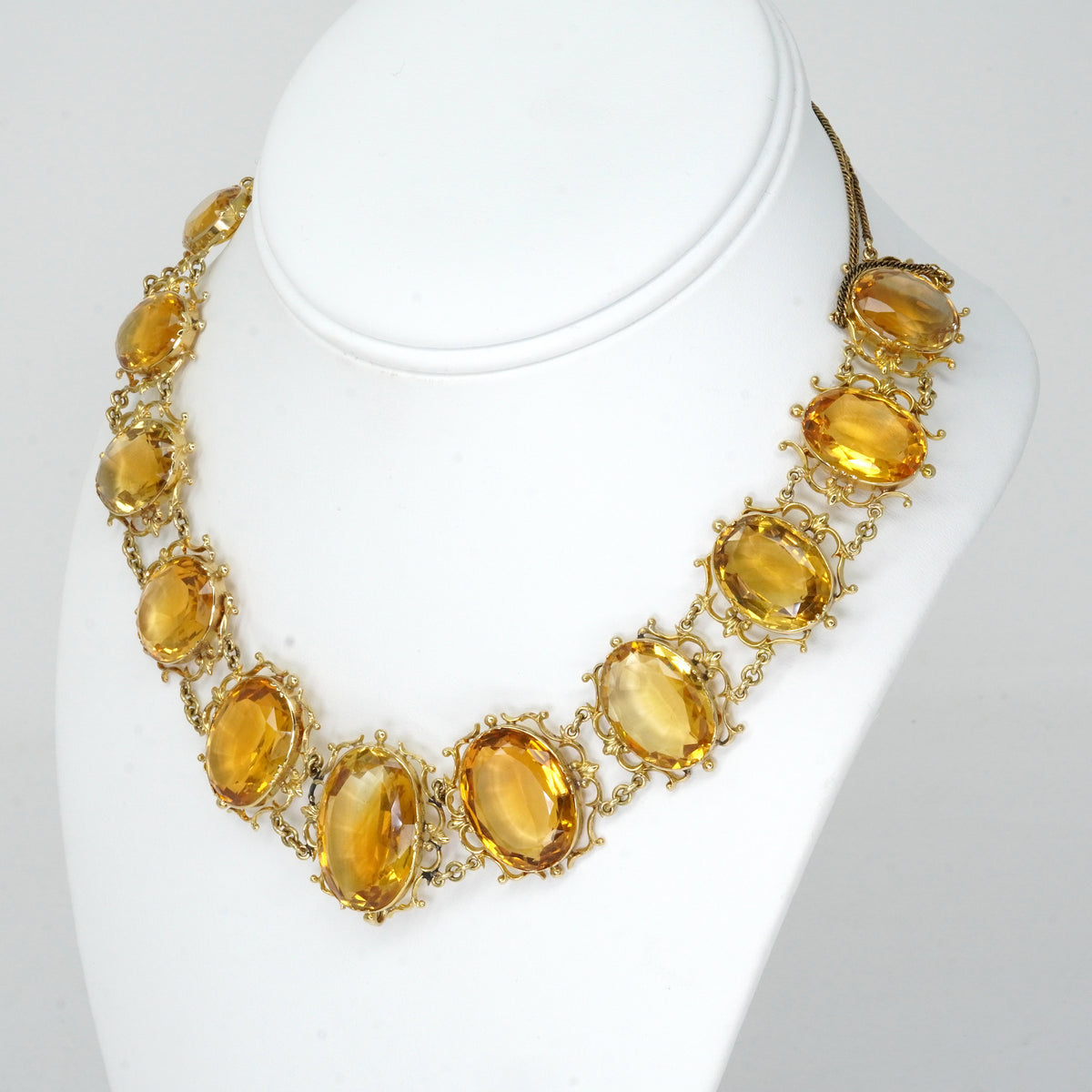 Antique Georgian Victorian Natural Oval Cut Citrine Necklace in 14K & 22K Yellow Gold with leaf and scroll motifs, on a bust.