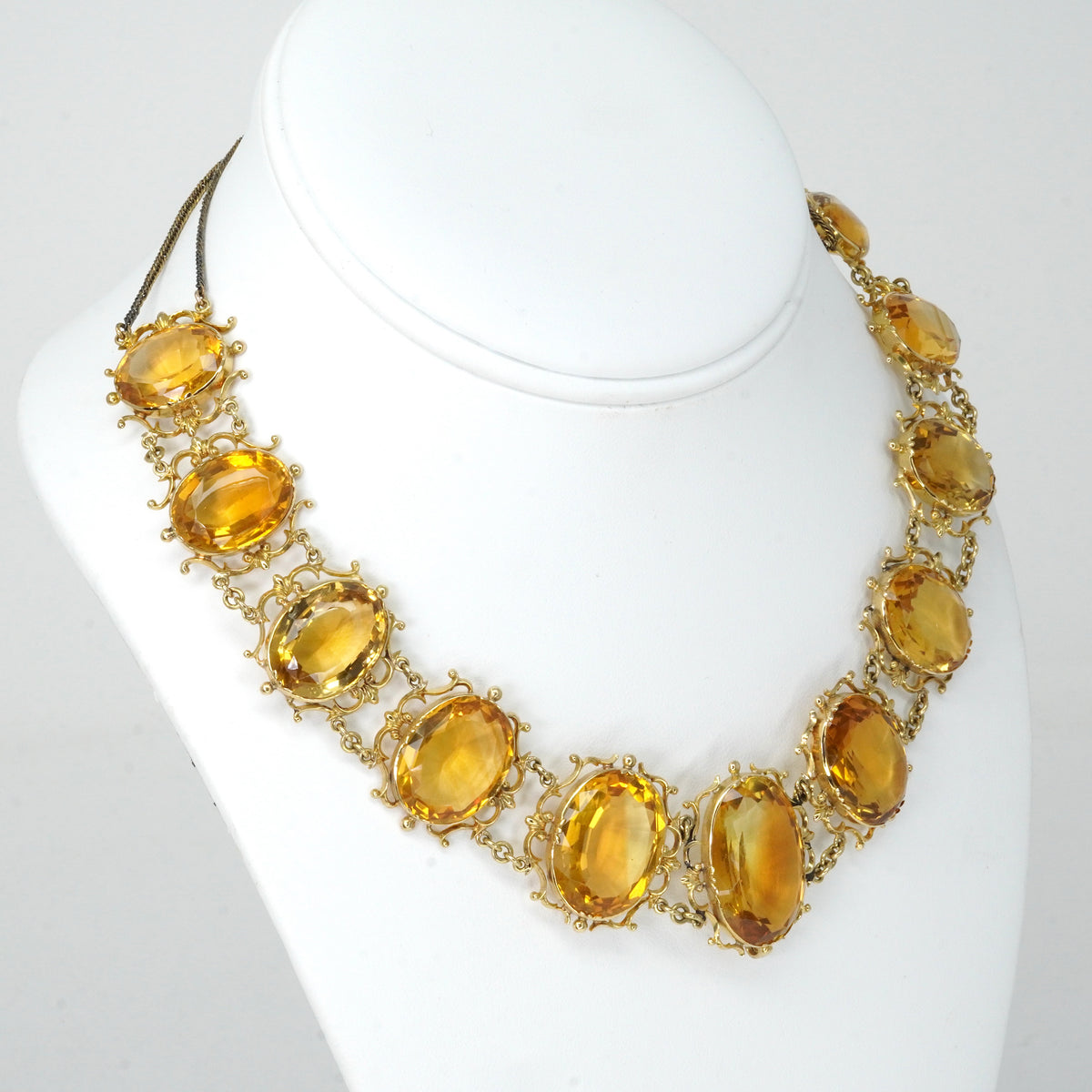 Antique Georgian Victorian Natural Oval Cut Citrine Necklace in 14K & 22K Yellow Gold with leaf and scroll motifs, on a bust.