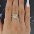 Tiffany and Co Soleste diamond and platinum ring with a 0.78 ct Fancy Intense yellow cushion cut diamond, front view of ring on a models hand.