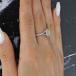 Tiffany and Co Soleste diamond and platinum ring with a 0.78 ct Fancy Intense yellow cushion cut diamond, side view of ring on a models hand.