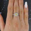 Tiffany and Co Soleste diamond and platinum ring with a 0.78 ct Fancy Intense yellow cushion cut diamond, front view of ring on a models hand.