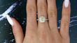 Tiffany and Co Soleste diamond and platinum ring with a 0.78 ct Fancy Intense yellow cushion cut diamond, front view of ring on a models hand, video format.